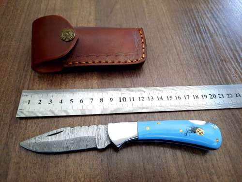 Handmade Damascus steel folding knife with Epoxy Resin handle scales. Leather pouch included.