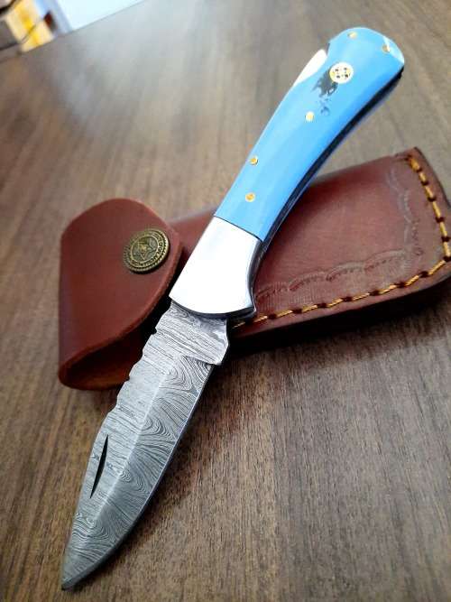 Handmade Damascus steel folding knife with Epoxy Resin handle scales. Leather pouch included.