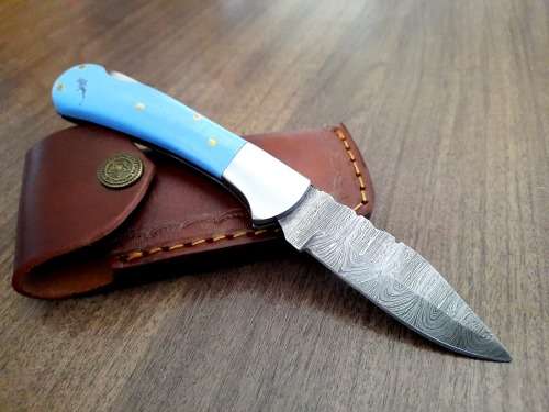 Handmade Damascus steel folding knife with Epoxy Resin handle scales. Leather pouch included.