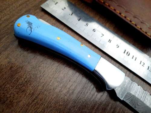 Handmade Damascus steel folding knife with Epoxy Resin handle scales. Leather pouch included.