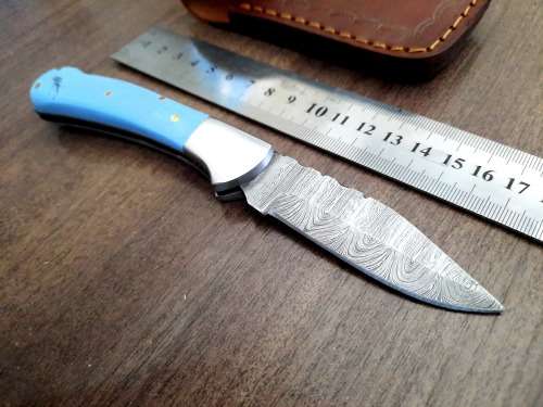 Handmade Damascus steel folding knife with Epoxy Resin handle scales. Leather pouch included.