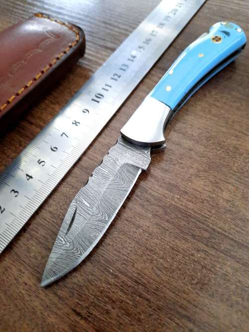 Handmade Damascus steel folding knife with Epoxy Resin handle scales. Leather pouch included.