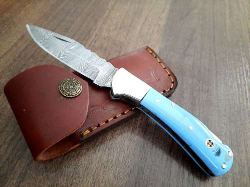 Handmade Damascus steel folding knife with Epoxy Resin handle scales. Leather pouch included.