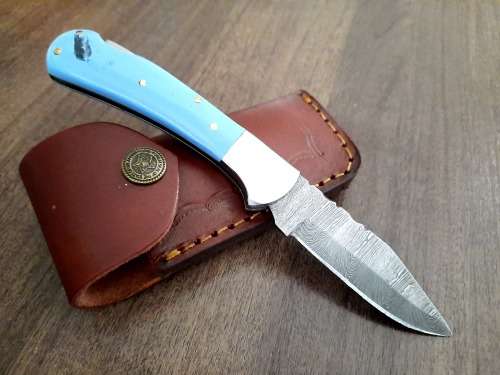Handmade Damascus steel folding knife with Epoxy Resin handle scales. Leather pouch included.