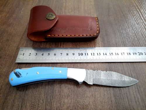 Handmade Damascus steel folding knife with Epoxy Resin handle scales. Leather pouch included.
