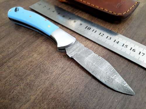 Handmade Damascus steel folding knife with Epoxy Resin handle scales. Leather pouch included.