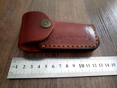 Handmade Damascus steel folding knife with Epoxy Resin handle scales. Leather pouch included.