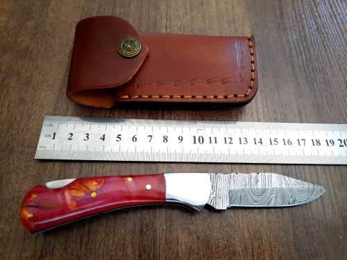 Handmade Damascus steel folding knife with Epoxy Resin handle scales. Leather pouch included.
