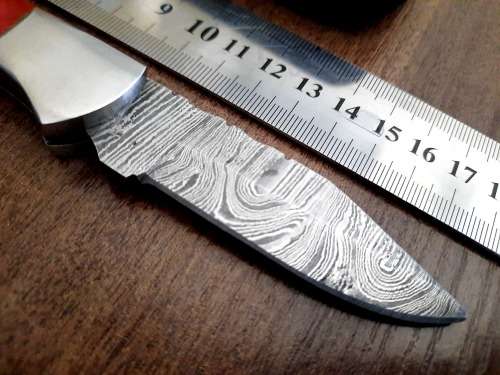 Handmade Damascus steel folding knife with Epoxy Resin handle scales. Leather pouch included.