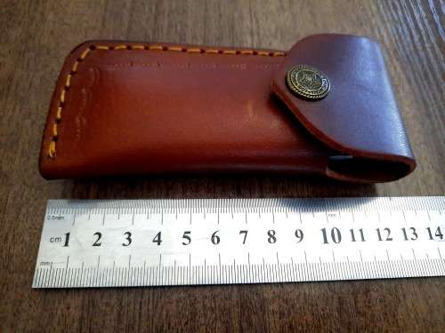 Handmade Damascus steel folding knife with Epoxy Resin handle scales. Leather pouch included.