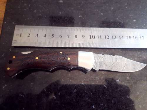 Handmade Damascus steel folding knife w Wooden Handle Scales. Pouch in bad shape, see pictures.