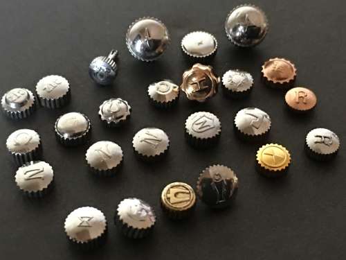Assortment of 25 signed watch crowns