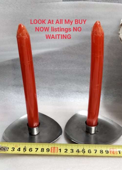 2 stainless steel candle holders and 2 red candles not used