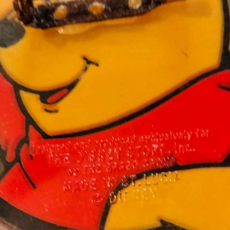 Poo Bear Pin back says  Disney Store St Lucia