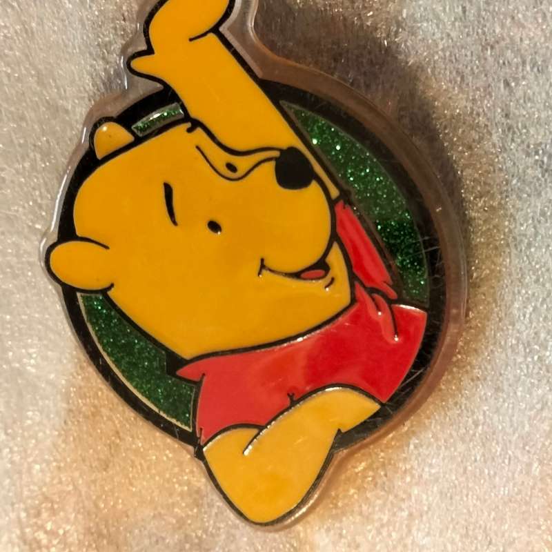 Poo Bear Pin back says  Disney Store St Lucia