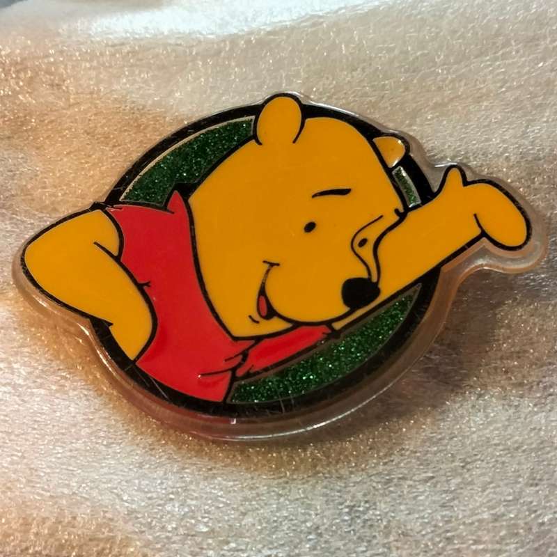 Poo Bear Pin back says  Disney Store St Lucia