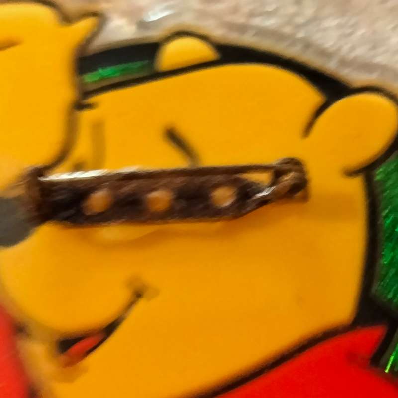 Poo Bear Pin back says  Disney Store St Lucia