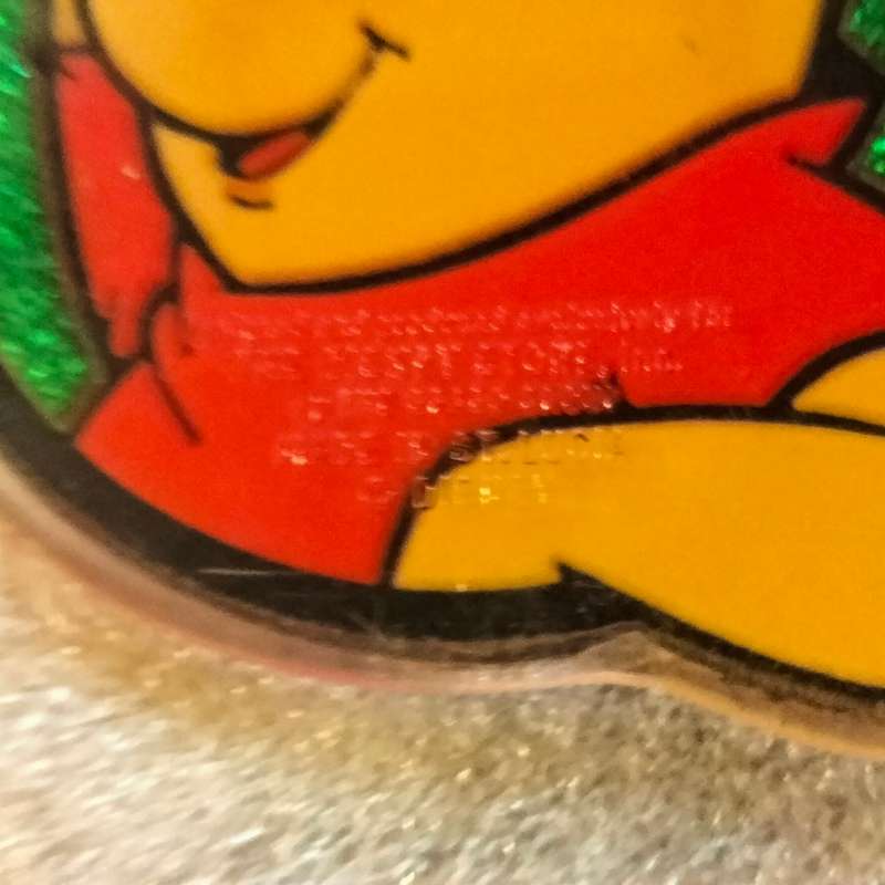 Poo Bear Pin back says  Disney Store St Lucia
