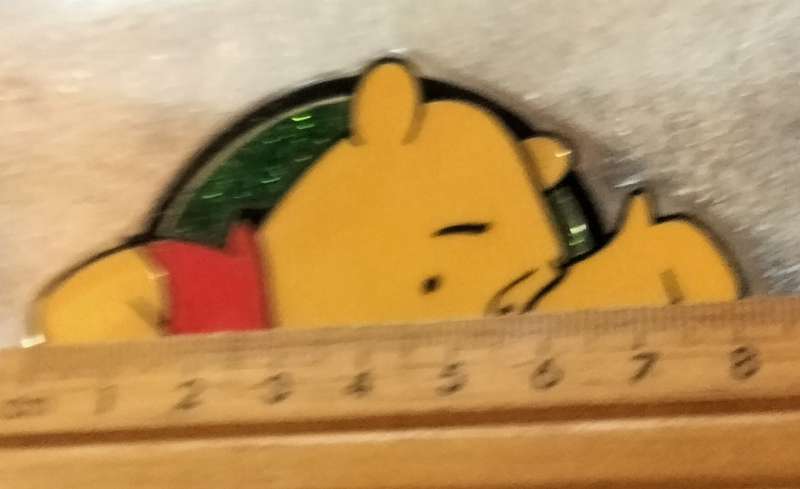 Poo Bear Pin back says  Disney Store St Lucia