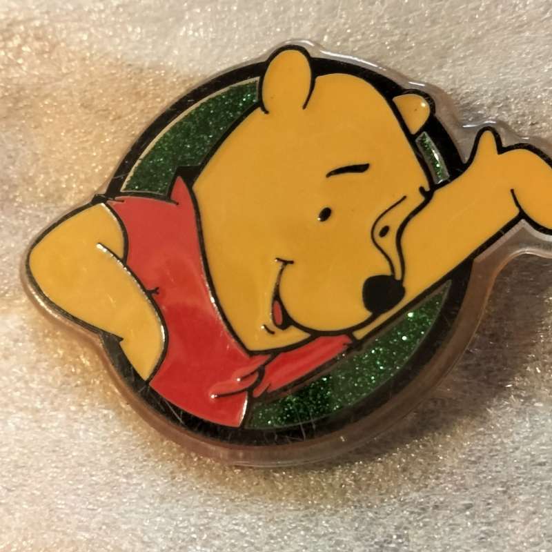 Poo Bear Pin back says  Disney Store St Lucia
