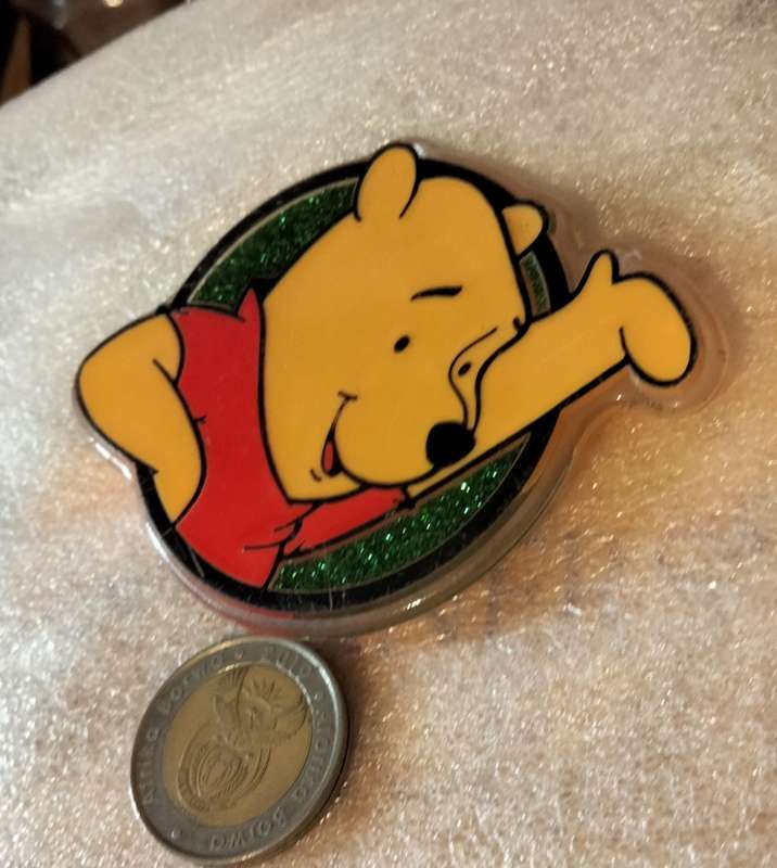 Poo Bear Pin back says  Disney Store St Lucia