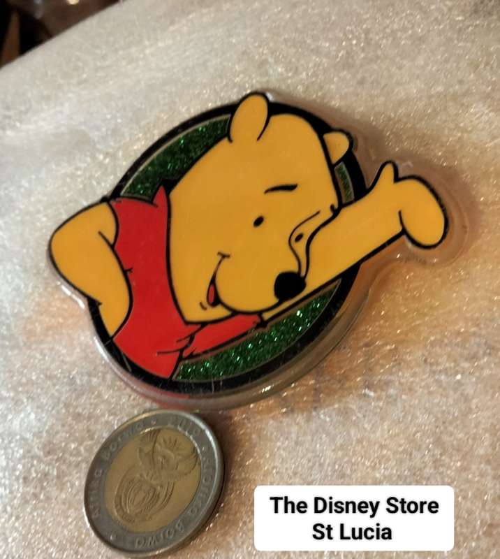 Poo Bear Pin back says  Disney Store St Lucia