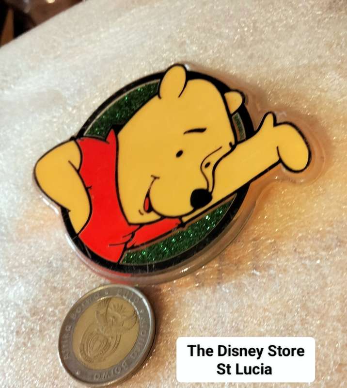 Poo Bear Pin back says  Disney Store St Lucia