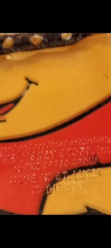 Poo Bear Pin back says  Disney Store St Lucia