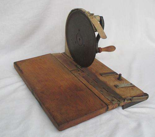 VINTAGE BREAD SLICER ON WOODEN BOARD