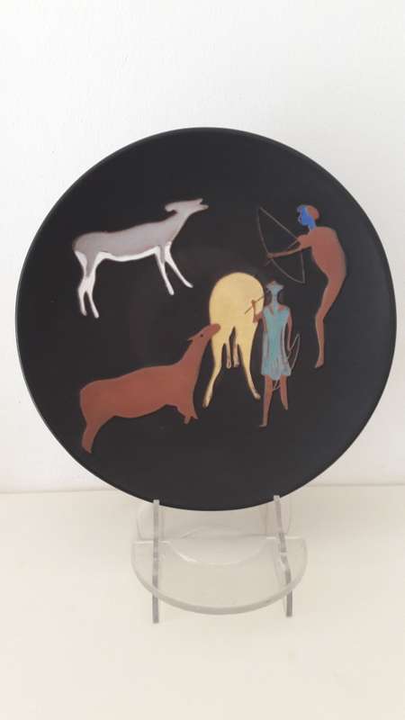 Kalahari ceramic wall charger with San Bushman motif hunters and antelope .