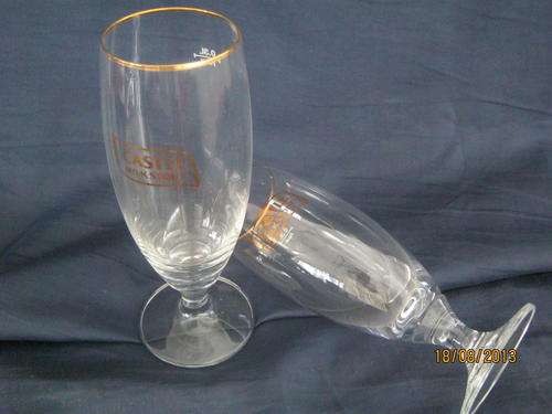 A pair of stemmed CASTLE MILK STOUT Glasses
