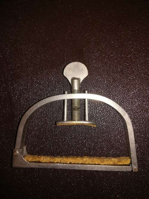 Vintage metal and cork guitar capo.