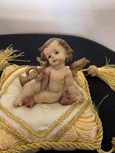 CHERUB HOLDING THE BUGLE SITTING ON GOLD BRAIDED CUSHION