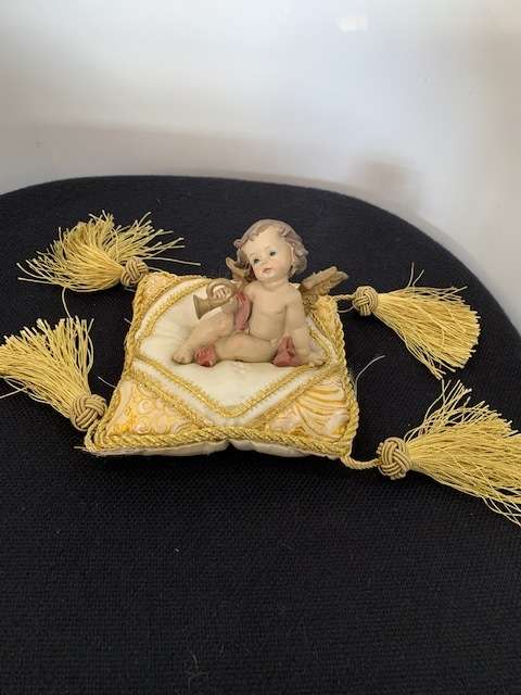 CHERUB HOLDING THE BUGLE SITTING ON GOLD BRAIDED CUSHION