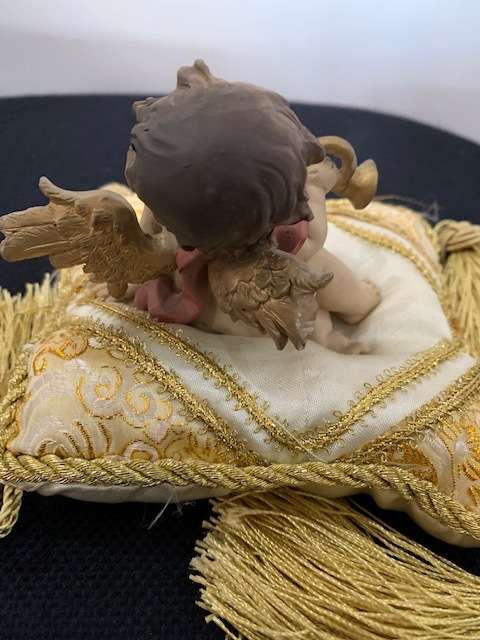 CHERUB HOLDING THE BUGLE SITTING ON GOLD BRAIDED CUSHION