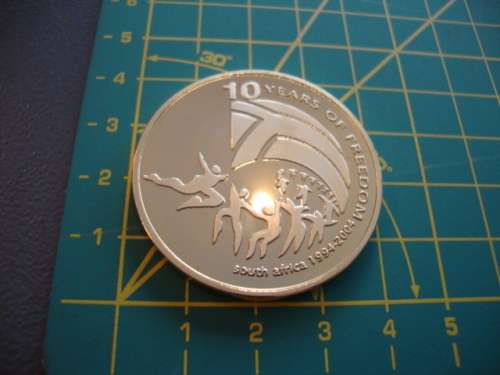 Gold Plated Mandela "Ten Years of Freedom" commemorative token.