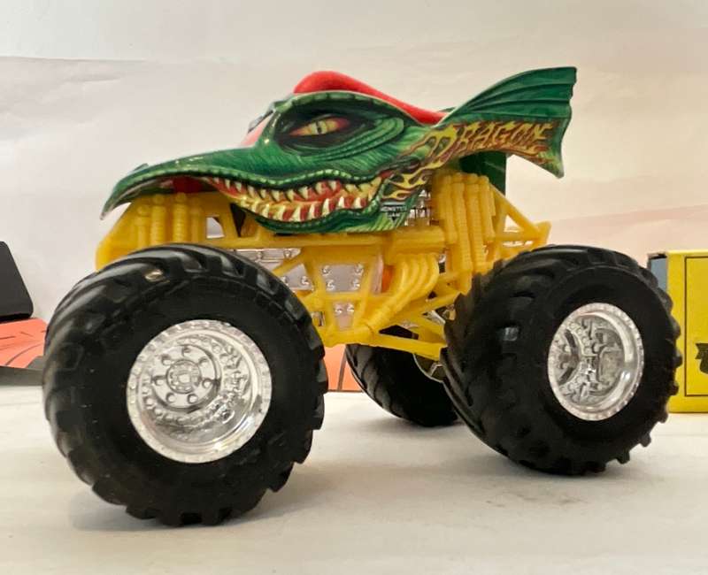 Assorted three toy cars, including a Monster Jam model