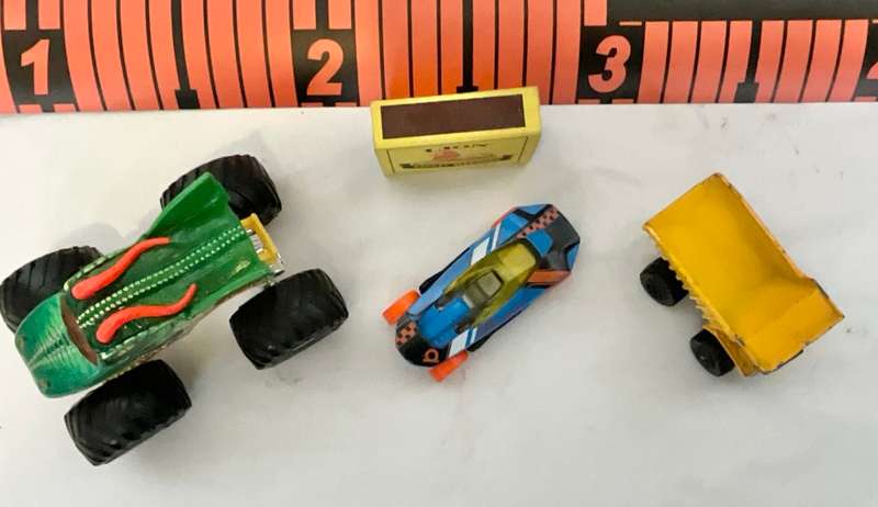 Assorted three toy cars, including a Monster Jam model