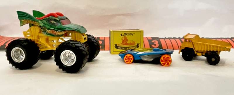 Assorted three toy cars, including a Monster Jam model