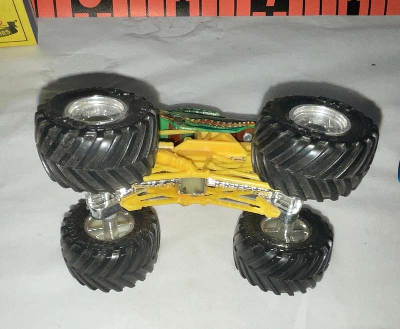 Assorted three toy cars, including a Monster Jam model