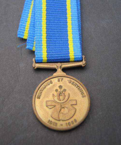 MINT "75 YEARS" COMMEMORATION MINIATURE MEDAL WITH RIBBON.