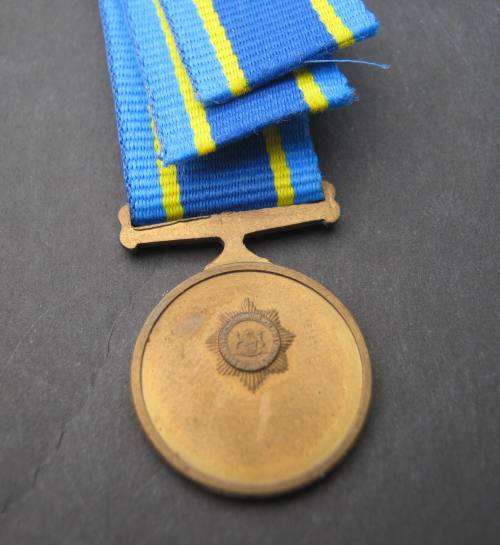 MINT "75 YEARS" COMMEMORATION MINIATURE MEDAL WITH RIBBON.