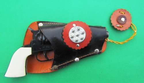OLD DIE-CAST METAL "COLT" COWBOY CAP GUN WITH LEATHER HOLSTER. MADE IN ENGLAND IN THE SIXTIES.