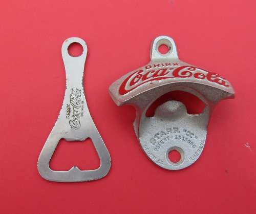 SCARCE `COCA-COLA` METAL BOTTLE OPENERS. ONE VINTAGE AND THE OTHER GENUINE AND UNUSED.