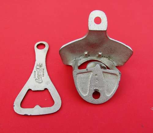 SCARCE `COCA-COLA` METAL BOTTLE OPENERS. ONE VINTAGE AND THE OTHER GENUINE AND UNUSED.