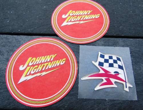 TWO JOHNNY LIGHTNING COASTERS AND A VINTAGE UNUSED `SASOL` STICKER.