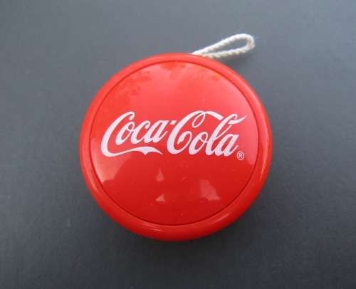 GENUINE `COCA-COLA` YO-YO WITH STRING IN VIBRANT ORANGE COLOR. IN VERY GOOD CONDITION.