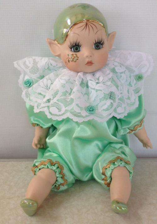 Porcelain Pixie doll dressed in green coloured suite - Artist 'Loe'