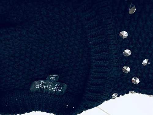 10 / 34 designer is TOPSHOP black knit wear embellished /shoulder detail.