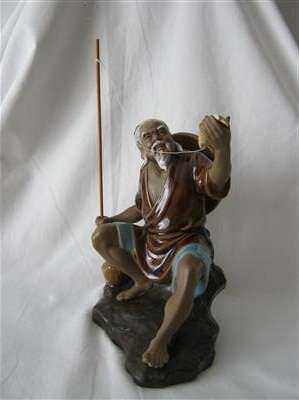 VINTAGE CERAMIC CHINESE FISHERMAN FIGURINE.. 17.50cm HIGH X 15cm LONG X8.50wcm WIDE